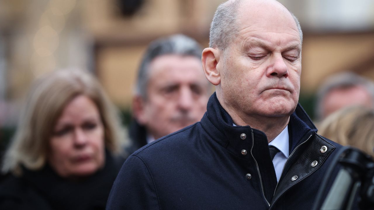 German Chancellor Olaf Scholz reacts during a visit to the site of a car-ramming attack on a Christmas market in Magdeburg, eastern Germany, on December 21, 2024, resulting in several deaths and dozens of injured. German media reports that the death toll has risen to five over night and up to 200 injured in the attack on December 20th. (Photo by Ronny HARTMANN / AFP) (Photo by RONNY HARTMANN/AFP via Getty Images)