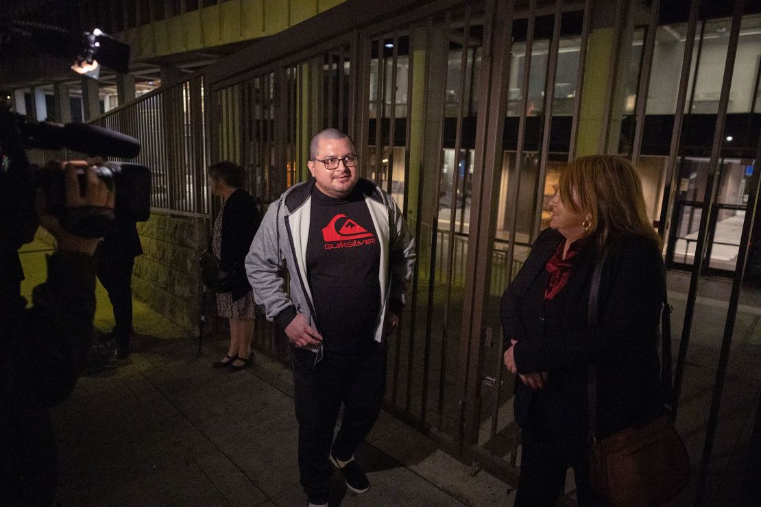 Lombardo Palacios, left, who was 15 when he was arrested, walks out of court a free man with his mother, Carla Campos, on Friday.