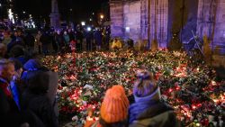 People visit a makeshift memorial near the Christmas market in Magdeburg, Germany, on December 21.