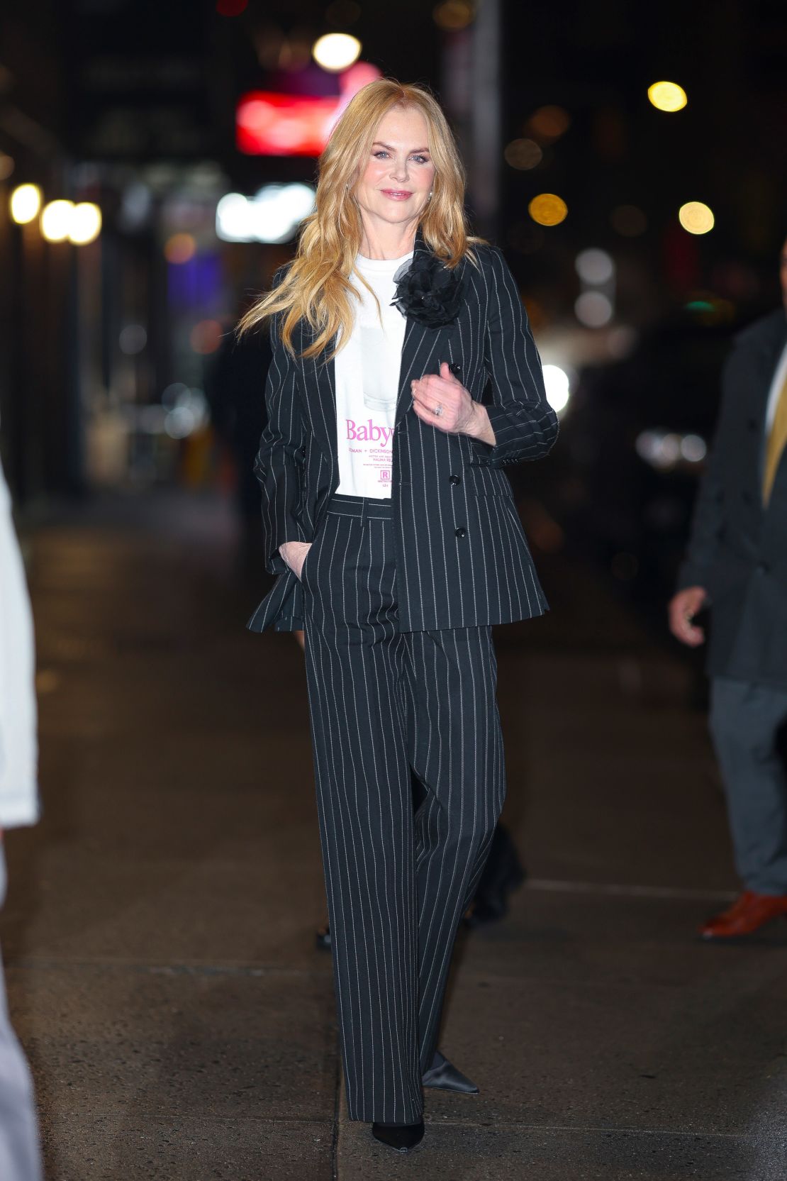 Kidman paired her pinstriped suit with a piece of official