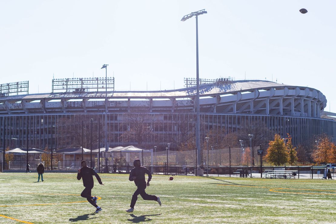 D'marco Dixon, left, attempts to catch a football beside his brother, Seanery Dixon, near Robert F. Kennedy Stadium on December 22, 2024 in Washington, DC. The Robert F. Kennedy Memorial Stadium Campus Revitalization Act passed the US Senate early December 21.