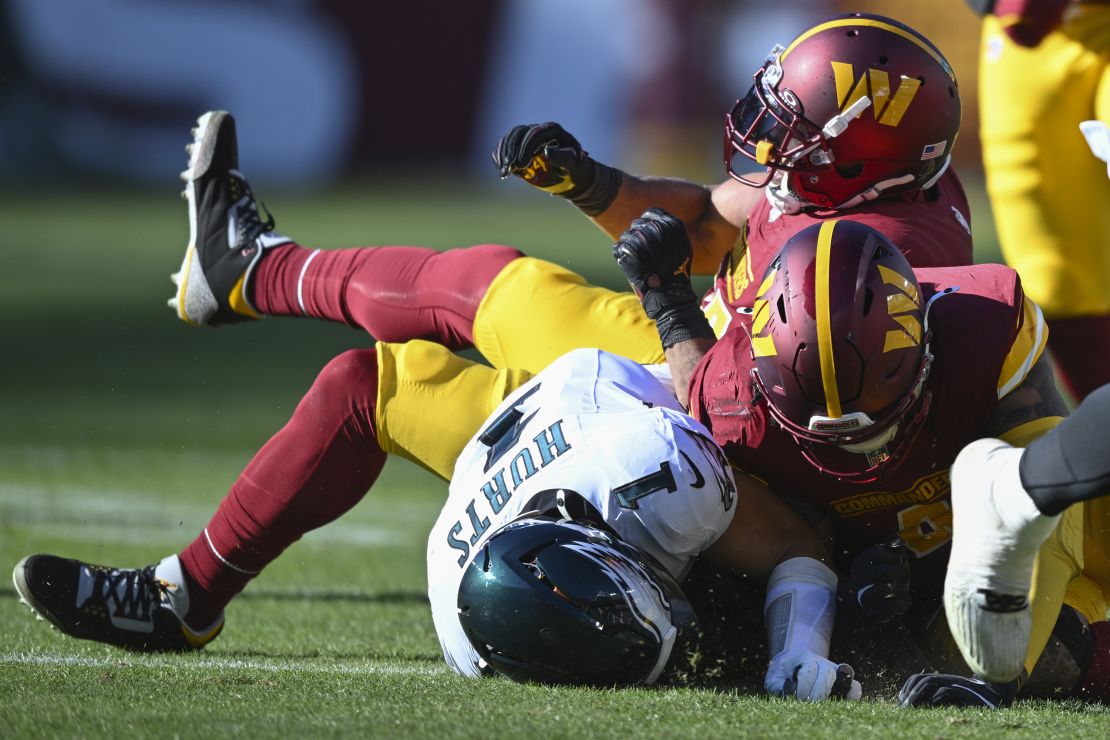 LANDOVER, MD - DECEMBER 22: Philadelphia Eagles quarterback Jalen Hurts (1) is knocked out of the game on a tackle by Washington Commanders linebacker Bobby Wagner, top and Commanders linebacker Frankie Luvu at the Northwest Stadium in Landover, MD on December 22, 2024. (Photo by John McDonnell/ for The Washington Post via Getty Images)