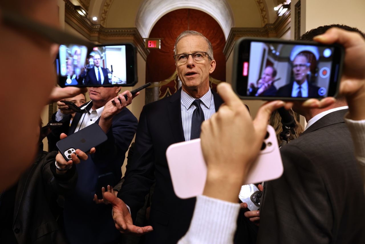 John Thune talks to reporters at the US Capitol in Washington, DC, on December 18.