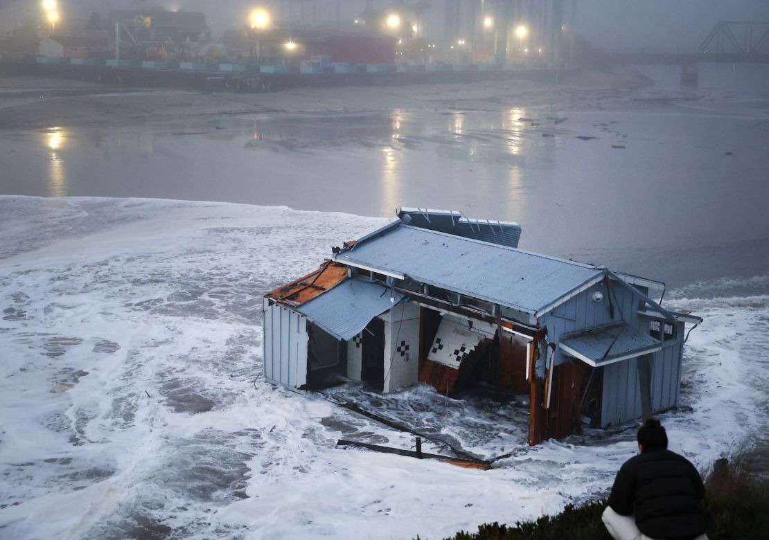 People look at a portion of the collapsed pier at the Santa Cruz Wharf in Santa Cruz, California, on Monday.