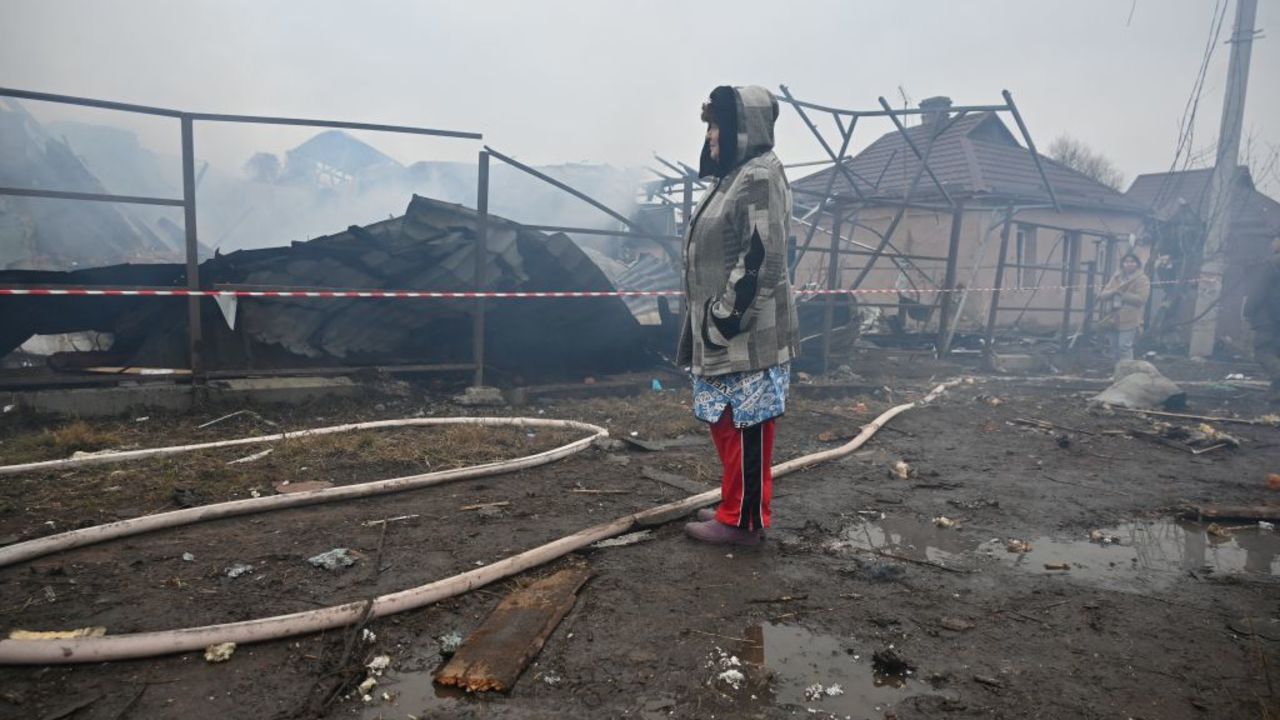 TOPSHOT - A local resident reacts as she looks at her neighbours' house, which was destroyed in a drone strike in Kharkiv, on December 25, 2024, amid the Russian invasion in Ukraine. The Ukrainian president on December 25 denounced as an "inhumane" attack from Russia, which launched over 170 missiles and drones on his war-torn country's power grid on Christmas Day, killing one and causing widespread blackouts. The country woke up at 5:30 am (0330 GMT) to an air raid alarm, shortly followed by air force reports that Russia had launched Kalibr cruise missiles from the Black Sea. (Photo by SERGEY BOBOK / AFP) (Photo by SERGEY BOBOK/AFP via Getty Images)