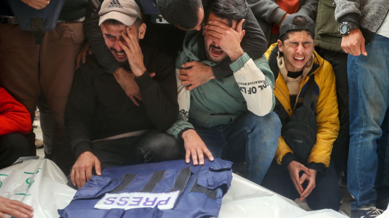 Mourners attend the funeral of members of the press who were killed in an Israeli strike, at the al-Awda Hospital in the Nuseirat refugee camp in the central Gaza Strip, on December 26, 2024. A Palestinian TV channel affiliated with the militant group Islamic Jihad said five of its journalists were killed on December 26, in an Israeli strike on their vehicle, with Israel's military saying it had targeted a "terrorist cell". A missile hit the journalists' broadcast truck as it was parked in the Nuseirat camp in central Gaza, according to a statement from their employer, Al-Quds Today. (Photo by Eyad BABA / AFP) (Photo by EYAD BABA/AFP via Getty Images)