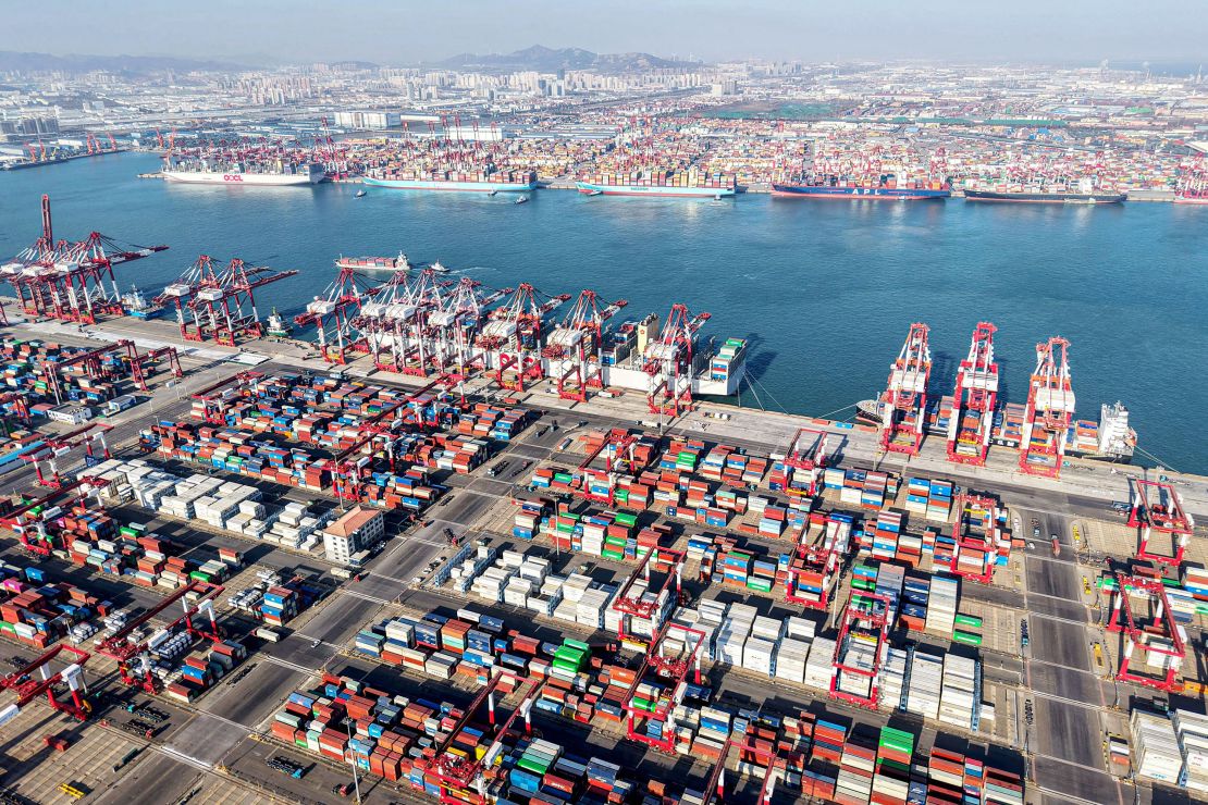 Shipping containers and gantry cranes are seen at Qingdao port in Qingdao, in eastern China