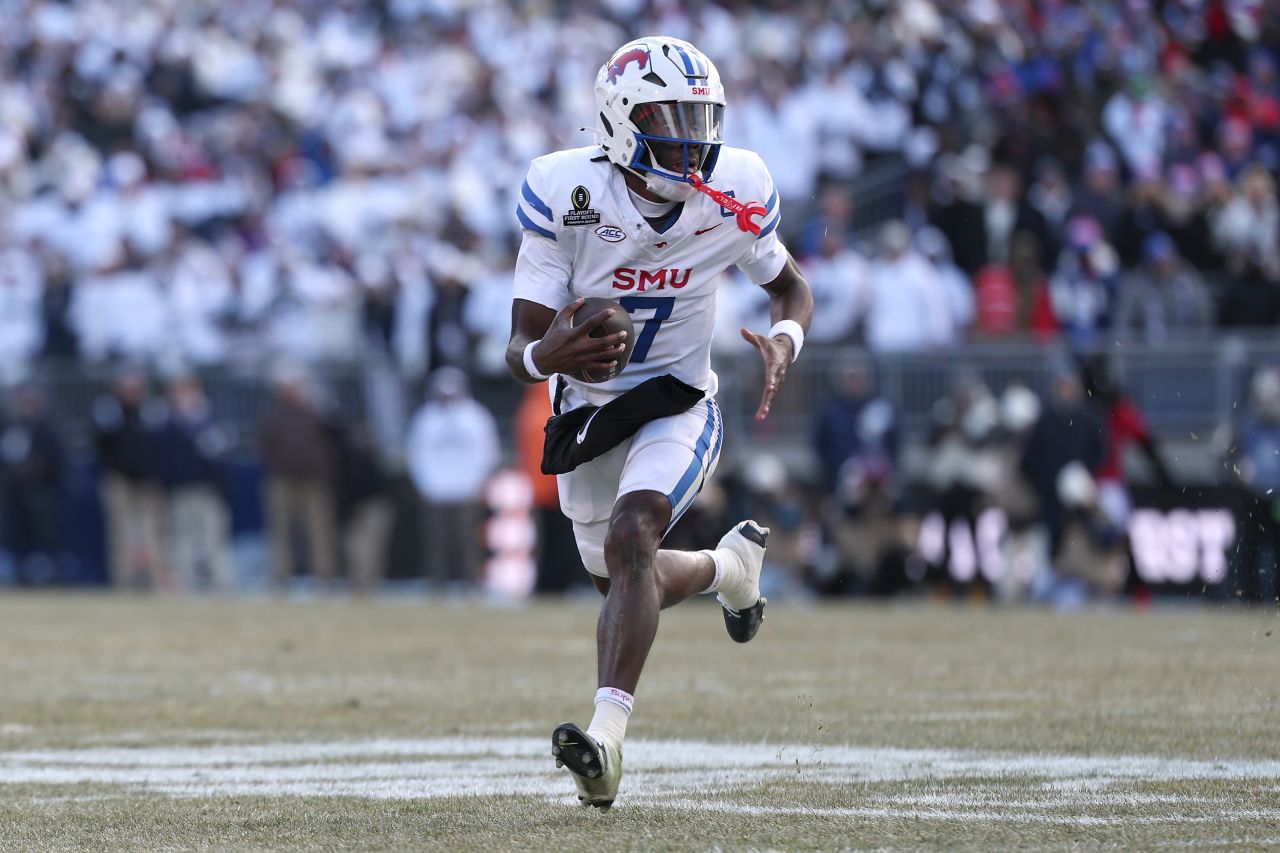 STATE COLLEGE, PENNSYLVANIA - DECEMBER 21: Kevin Jennings #7 of the Southern Methodist Mustangs scrambles with the ball during the first quarter against the Penn State Nittany Lions in the Playoff First Round Game at Beaver Stadium on December 21, 2024 in State College, Pennsylvania. (Photo by Scott Taetsch/Getty Images)