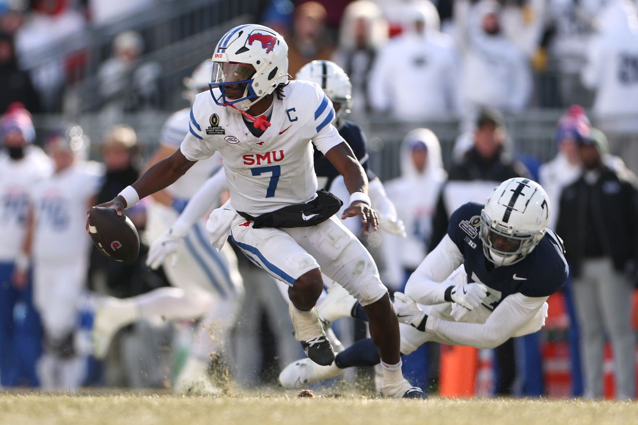 STATE COLLEGE, PENNSYLVANIA - DECEMBER 21: Kevin Jennings #7 of the Southern Methodist Mustangs scrambles with the ball during the second quarter against the Penn State Nittany Lions in the Playoff First Round Game at Beaver Stadium on December 21, 2024 in State College, Pennsylvania. (Photo by Scott Taetsch/Getty Images)