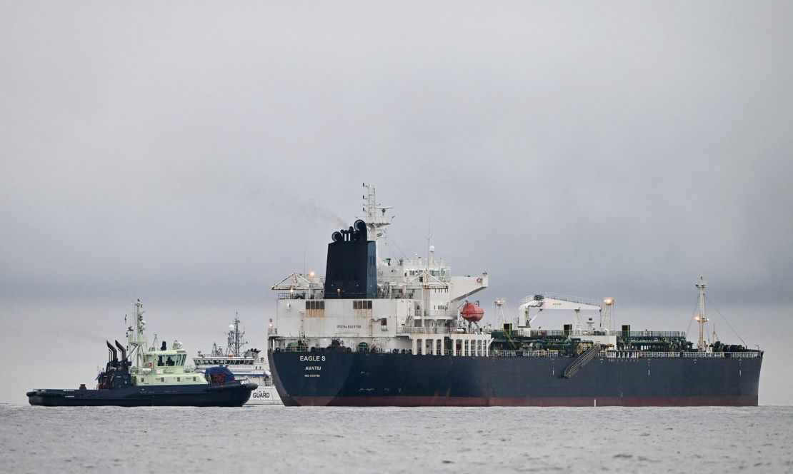 A photo taken on December 28, 2024, in the Gulf of Finland, shows Cook Islands-flagged oil tanker Eagle S (right), next to a Finnish border guard ship and tugboat.