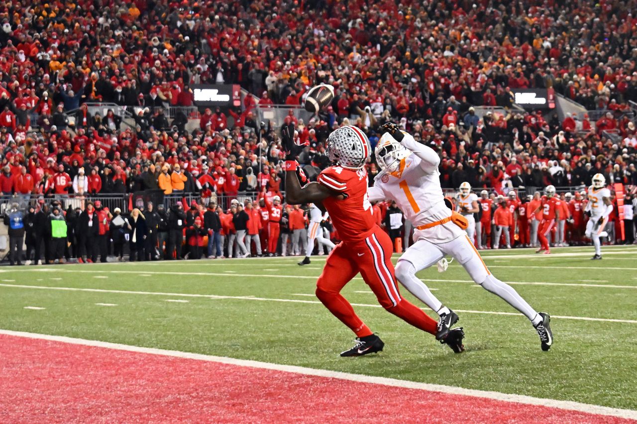 Ohio State wide receiver Jeremiah Smith catches a touchdown pass ahead of Tennessee's Rickey Gibson III during the first quarter.