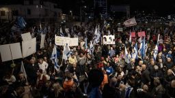 TEL AVIV, ISRAEL - DECEMBER 28: Hundreds of people gather to hold a demonstration demanding a ceasefire and a hostage swap agreement in Gaza, on December 28, 2024, in Tel Aviv, Israel. Carrying banners, posters, and placards calling for an end to the war, the demonstrators chanted slogans against Prime Minister Benjamin Netanyahu and his government. (Photo by Mostafa Alkharouf/Anadolu via Getty Images)