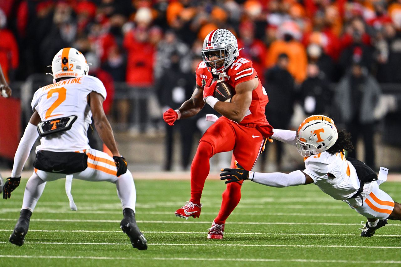 Ohio State running back TreVeyon Henderson carries the ball while defended by Tennessee's Jermod McCoy and Andre Turrentine during the first half.