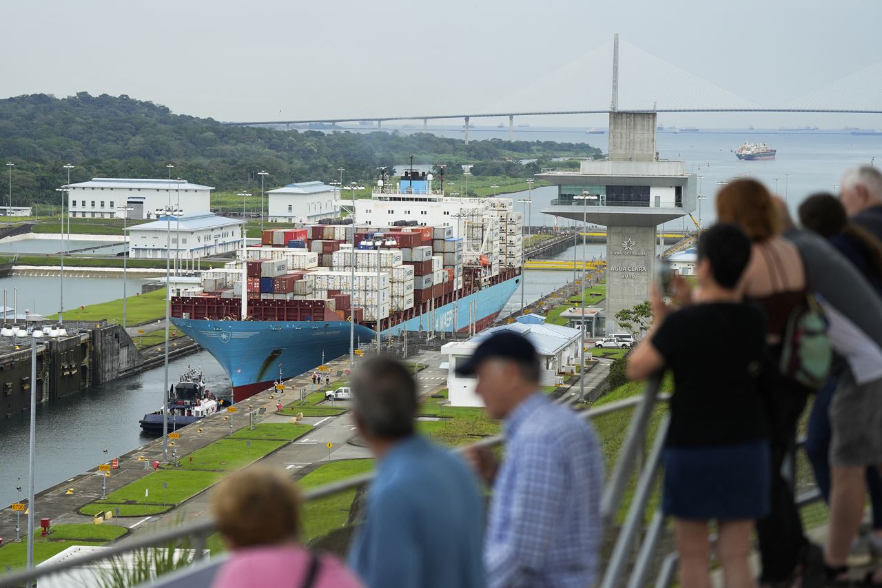 Tourists look at the Danish cargo ship Lars Maersk sailing through the Agua Clara Locks of the Panama Canal in Colon City, Panama, on December 28, 2024. On 31 December 2024, Panama celebrated the 25th anniversary of sovereignty over the Canal.