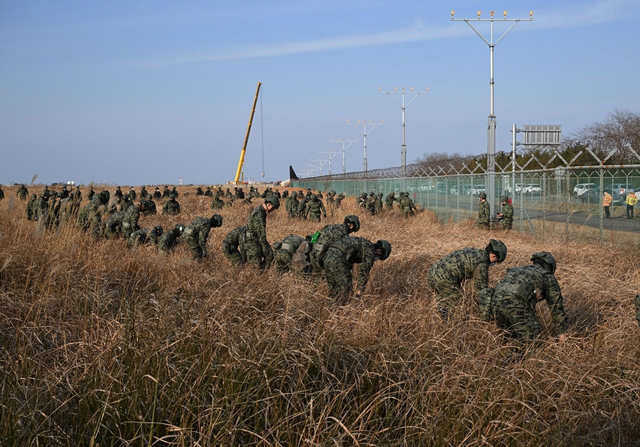 South Korean soldiers work near the scene of the crash.