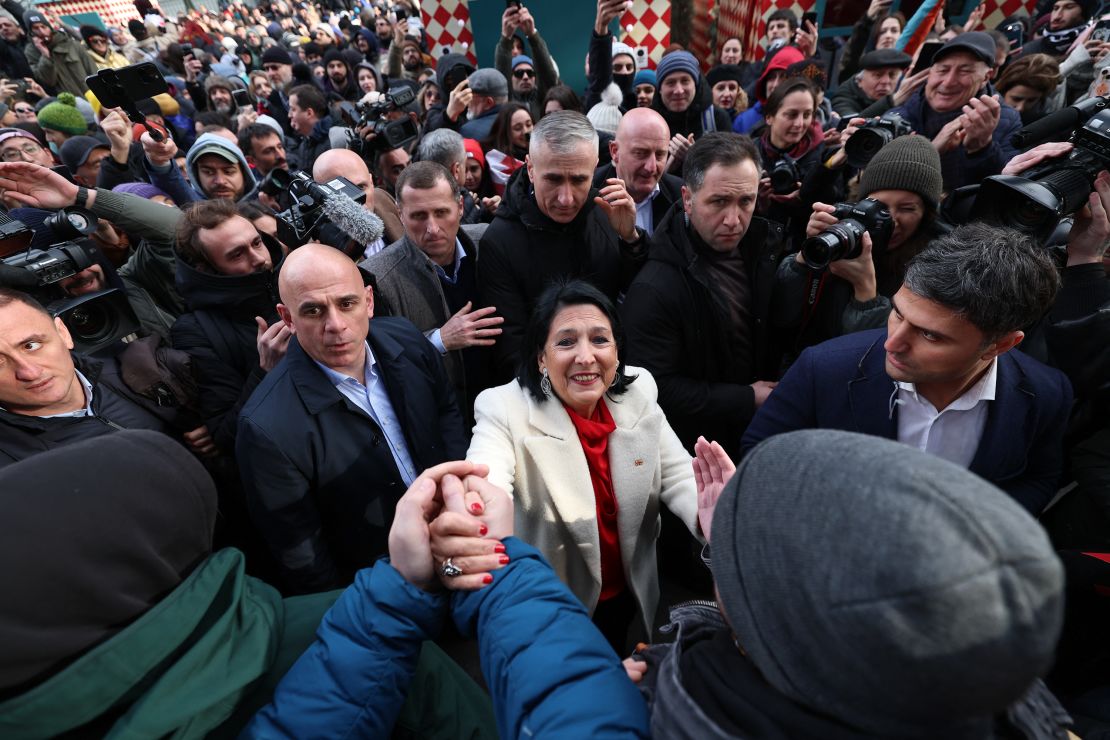 Georgia's outgoing pro-EU President Salome Zurabishvili (center) condemned her anti-Western successor, telling supporters on Sunday: “I am taking legitimacy with me."