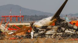 The localizer antenna facility, essential for guiding aircraft landings near the runway at Muan International Airport in Muan-gun, South Jeolla Province, South Korea, is damaged after a collision with Jeju Air Flight 7C2216 on December 29, 2024. Multiple international aviation experts point out that, unlike the standard design, where such facilities are placed at runway level or elevated on steel towers, the facility at Muan International Airport is secured with thick concrete on a 2-3 meter-high mound of soil. This unconventional design is highlighted as a potential key factor contributing to the tragedy. Jeju Air Flight 7C2216, a Boeing 737-800 carrying 181 people, skids off the runway and collides with a wall, triggering a devastating explosion. Only two crew members seated near the rear emergency exit survive. With 179 confirmed fatalities, this tragedy becomes the deadliest domestic passenger plane crash in South Korean history. Muan International Airport is located approximately 300 km southwest of central Seoul. (Photo by Chris Jung/NurPhoto via Getty Images)