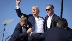 BUTLER, PENNSYLVANIA - JULY 13: Republican presidential candidate former President Donald Trump defiantly pumps his fist after being shot and rushed offstage during a rally on July 13, 2024 in Butler, Pennsylvania. Butler County district attorney Richard Goldinger said the gunman was shot and killed after injuring former U.S. President Donald Trump, killing one audience member and critically injuring two others in the shooting.  (Photo by Anna Moneymaker/Getty Images)