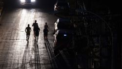 Joggers exercise on a dark street in San Juan, Puerto Rico after a major power outage hit the island on December 31, 2024. (Photo by Ricardo ARDUENGO / AFP) (Photo by RICARDO ARDUENGO/AFP via Getty Images)