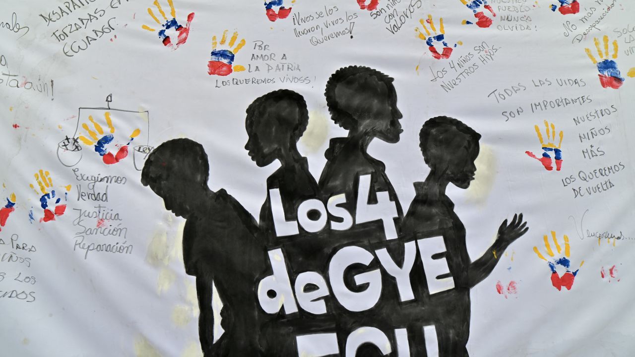 Protesters display a banner during a demonstrate against the disappearance of four minors who went missing during a military operation, outside the courthouse in Guayaquil, Ecuador, on December 31, 2024, during the arraignment hearing against 16 military personnel allegedly involved in the disappearance. The discovery on December 24 of several charred bodies during a search for the adolescent boys has deepened shock and anger at the case. Efforts to identify the four corpses found near an air force base have been complicated by their badly burned state. The minors went out to play football on December 8 and never came home. (Photo by Marcos PIN / AFP) (Photo by MARCOS PIN/AFP via Getty Images)