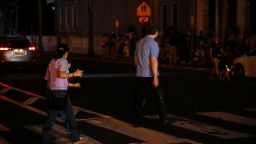 SAN JUAN, PUERTO RICO - DECEMBER 31: People walk on a dark street on December 31, 2024 in San Juan, Puerto Rico. The majority of the population on the island is without electricity due to a major power outage.