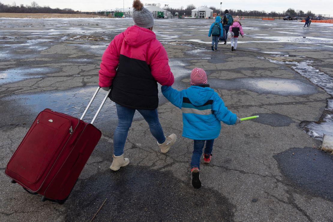 Migrant families come and go from the Floyd Bennett Field migrant shelter on December 25, 2024, in the New York borough of Queens.