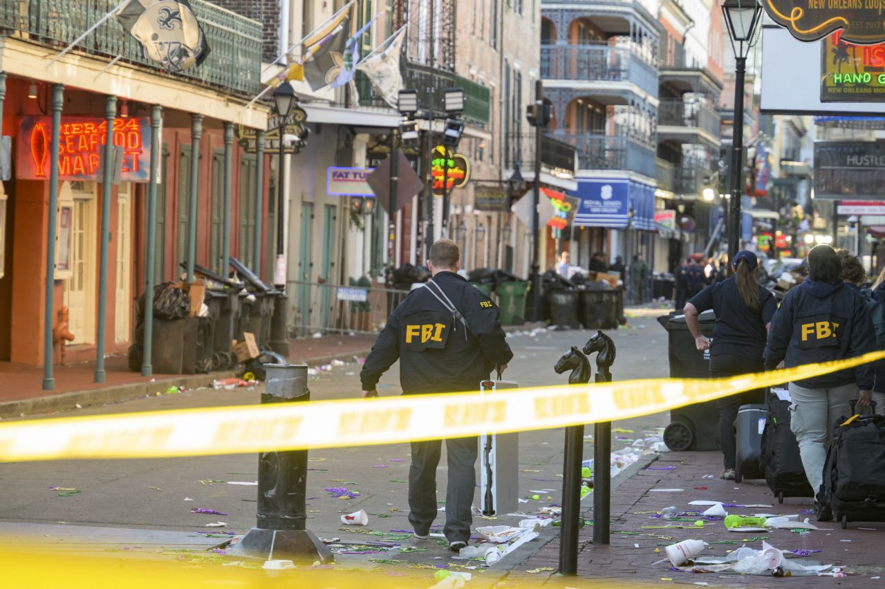 FBI investigators arrive at the scene where a truck that crashed into a work lift after allegedly driving into a crowd of New Year's revelers in the French Quarter of New Orleans, Louisiana, on Wednesday, January 1.