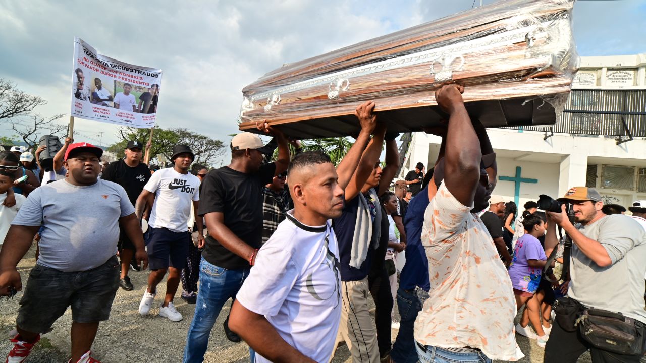 Relatives and friends of siblings Josue and Ismael Arroyo, 14 and 15, respectively, two of the four minors who disappeared during a military operation while playing football, carry one of the coffins during their burial at the Angel Maria Canals cemetery in Guayaquil, Ecuador, on January 1, 2025. The four Ecuadorian teenagers apprehended by soldiers and found dead near a military base were buried on Wednesday in the port of Guayaquil, amid outrage over the event that "mourns" the country, according to the government. (Photo by MARCOS PIN / AFP) (Photo by MARCOS PIN/AFP via Getty Images)