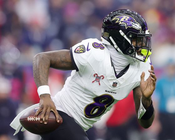 Baltimore Ravens quarterback Lamar Jackson runs the ball against the Houston Texans in Houston on Wednesday, December 25. The Ravens won 31-2, with Jackson <a href="index.php?page=&url=https%3A%2F%2Fwww.cnn.com%2F2024%2F12%2F25%2Fsport%2Fchiefs-ravens-win-christmas-day-spt%2Findex.html">breaking the record</a> for the most rushed yards by a quarterback, beating out Michael Vick's record.