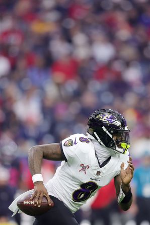 Baltimore Ravens quarterback Lamar Jackson runs the ball against the Houston Texans in Houston on Wednesday, December 25. The Ravens won 31-2, with Jackson <a  target="_top" href="/newspapers?url=https://www.cnn.com/2024/12/25/sport/chiefs-ravens-win-christmas-day-spt/index.html">breaking the record</a> for the most rushed yards by a quarterback, beating out Michael Vick's record.