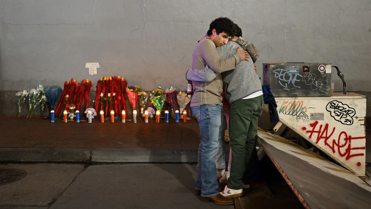 People react at a memorial set up on Bourbon Street on January 2, 2025 in New Orleans, Louisiana, the day after an attack by a man driving a truck down Bourbon street in the French Quarter.