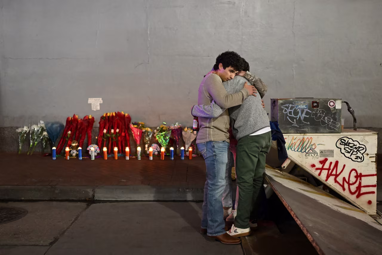 People react at a memorial set up on Bourbon Street in New Orleans, Louisiana on January 2.