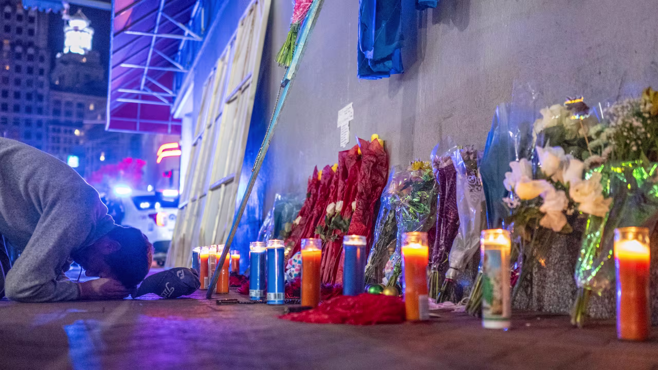 A man prays at a memorial on Bourbon Street, after it reopened to the public on January 2.