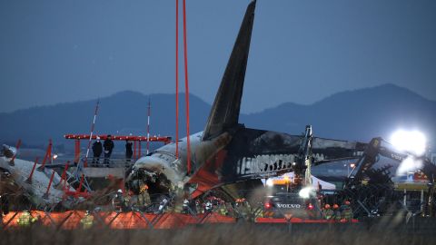 MUAN-GUN, SOUTH KOREA - DECEMBER 29: Firefighters and rescue teams work at the wreckage of a enger plane at Muan International Airport on December 29, 2024 in Muan-gun, South Korea. A plane carrying 181 people, Jeju Air Flight 7C2216, crashed at Muan International Airport in South Korea after skidding off the runway and colliding with a wall, resulting in an explosion. Early reports said that at least 179 people had died. (Photo by Chung Sung-Jun/Getty Images)