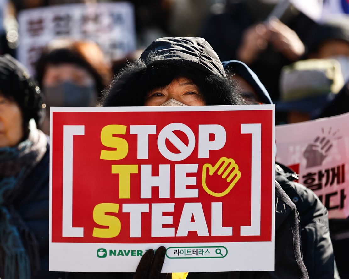 Protesters with both American and South Korean flags and 'Stop the Steal' placards gather to show support for suspended President Yoon Suk Yeol, in Seoul, South Korea, near the presidential residence, on January 4, 2025.