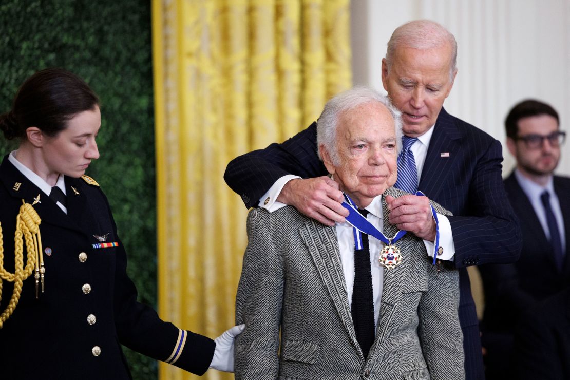 Capt. Rebecca Lobach escorts fashion designer Ralph Lauren as he is awarded the Presidential Medal of Freedom by President Joe Biden in the East Room of the White House on January 4, 2025.