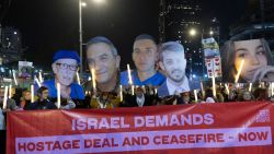 TEL AVIV, ISRAEL - JANUARY 4: Protesters hold photos of hostages held in the Gaza Strip and 100 light sticks to symbolize 100 hostages held by Hamas during a rally calling for a hostages deal on January 4, 2025 in Tel Aviv, Israel. Saturday night protests have occurred almost every week since late 2023, fusing anti-government sentiment with calls for a ceasefire with Hamas in Gaza. Earlier today, Hamas published a propaganda video with a statement from a female IDF observer, Liri Albag, who was taken hostage from Nahal Oz on Oct. 7, 2023. (Photo by Amir Levy/Getty Images)