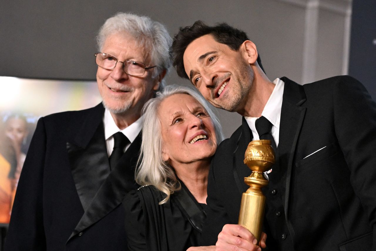 Adrien Brody poses with his parents after winning the Golden Globe for best male actor in a drama film.