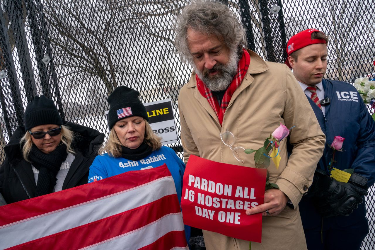 Supporters of Ashli Babbitt, who was killed on January 6, 2021, say a prayer during a memorial for Babbitt near the US Capitol in Washington, DC, on January 6. The group laid flowers and called for the release of those imprisoned for their actions on January 6.