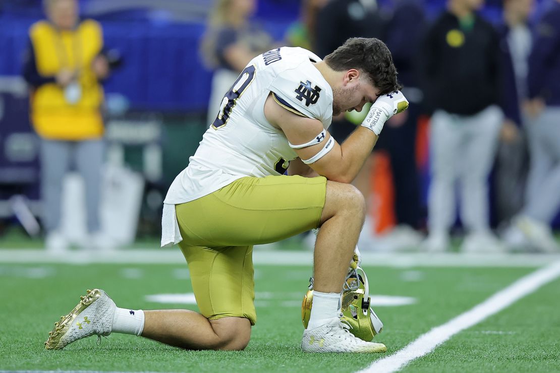 A Notre Dame player kneels and prays before kickoff of the Sugar Bowl in New Orleans.