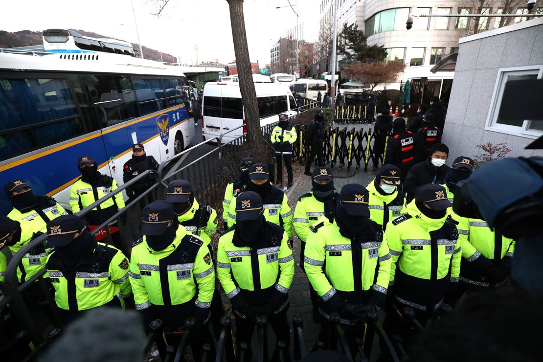 Police officers stand in front of suspended South Korean President Yoon Suk Yeol's official residence on January 3.