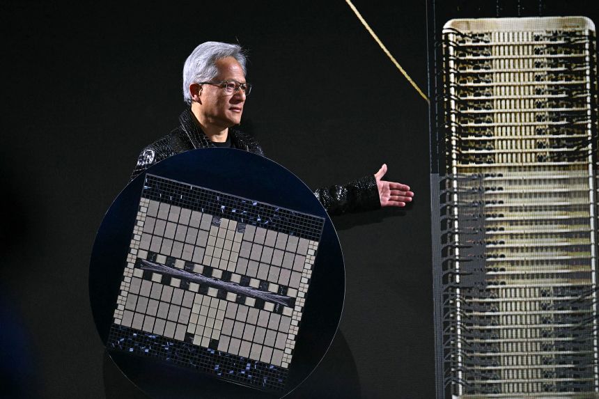 Nvidia CEO Jensen Huang holds a Grace Blackwell NVLink72.