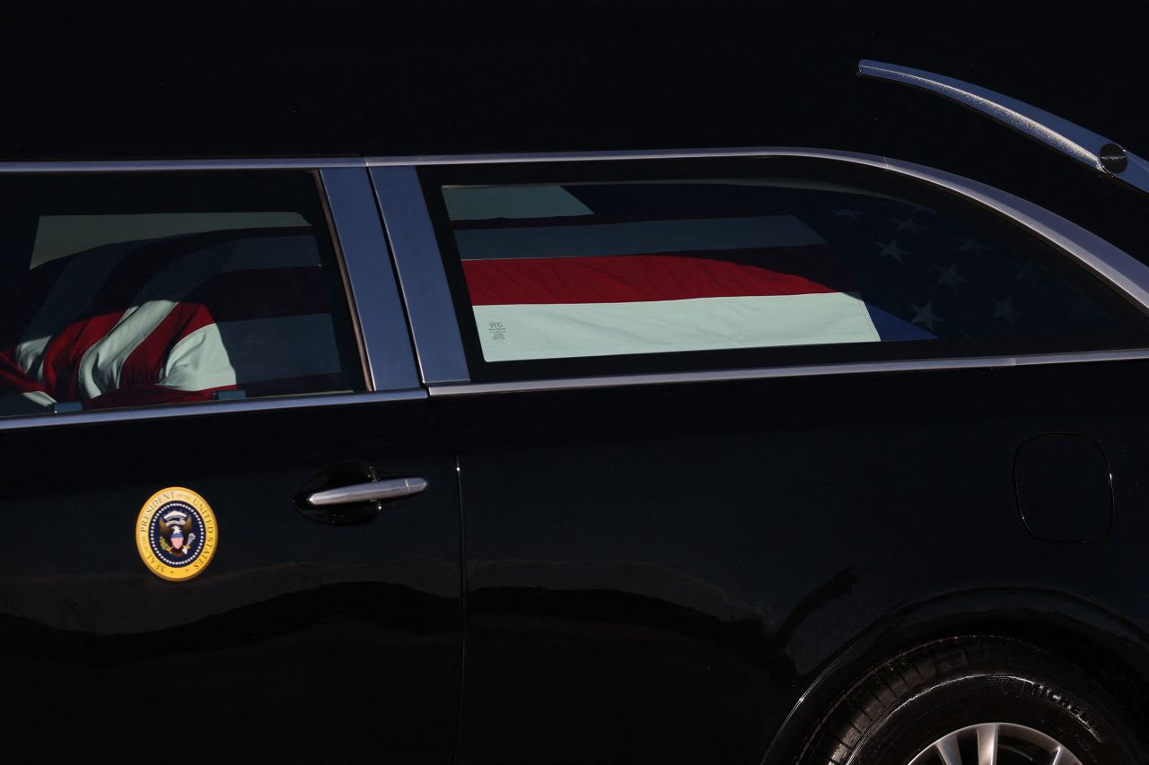 The flag-draped casket of former President Jimmy Carter is tranferred to a hearse during an arrival ceremony at Joint Base Andrews, Maryland, on January 7