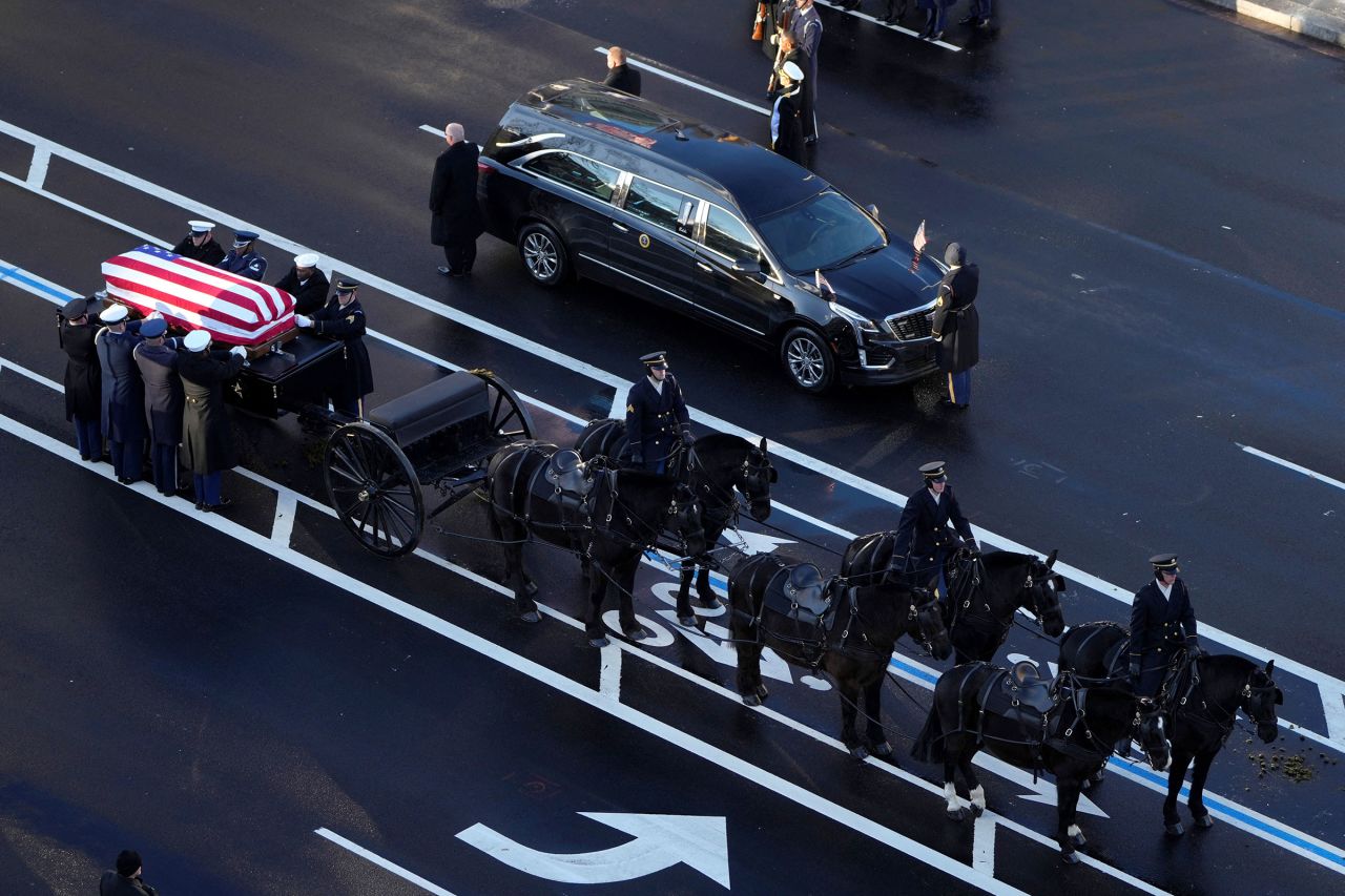 The flag-draped casket of former President Jimmy Carter is transferred to a horse-drawn caisson at the US Navy Memorial, before traveling on to the US Capitol, on January 7.