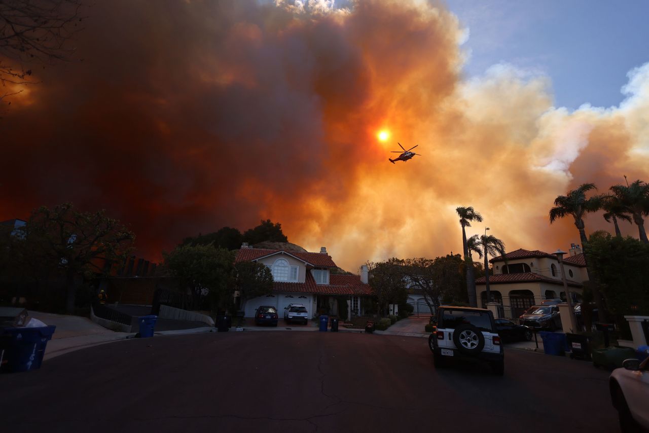 Plumes of smoke are seen as a brush fire burns in Pacific Palisades, California, on January 7.