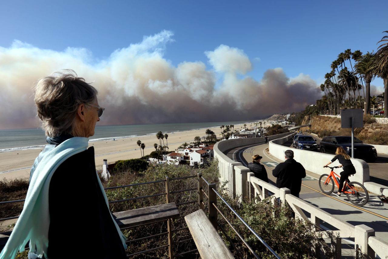 Palisades resident Maggie Stokes, 79, keeps an eye on the Palisades fire from Santa Monica. Stokes had to evacuate her home.