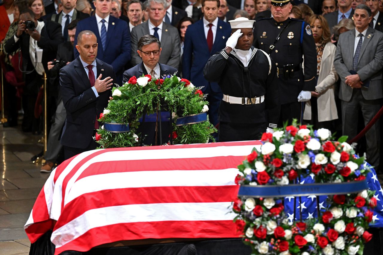 House Minority Leader Hakeem Jeffries and House Speaker Mike Johnson present a wreath as former President Jimmy Carter lies in state at the US Capitol Rotunda on January 7.