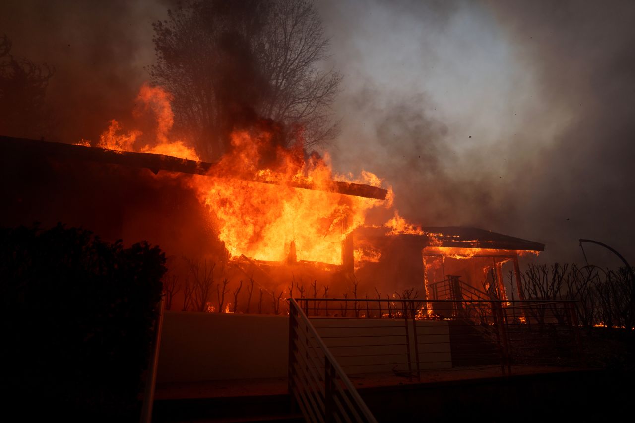 Flames from the Palisades Fire burn a home in the Pacific Palisades neighborhood of Los Angeles.