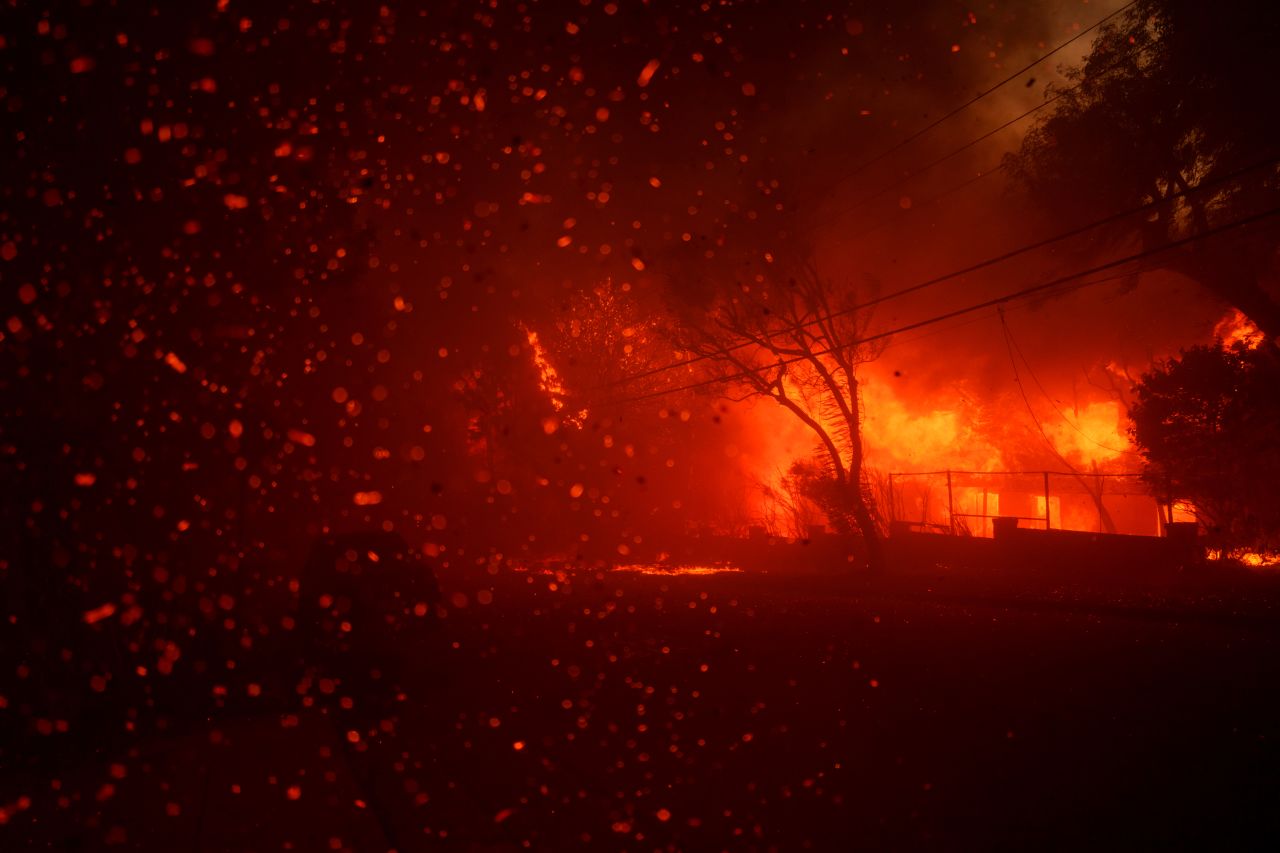 Flames from the Palisades Fire burn homes in the Pacific Palisades neighborhood of Los Angeles.