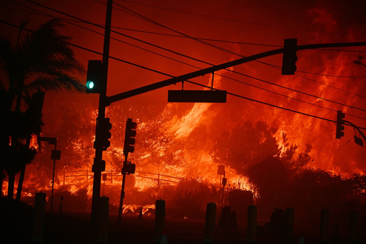 Flames overtake an intersection of the Temescal Canyon Road and the Pacific Coast Highway in Pacific Palisades, California on January 7.